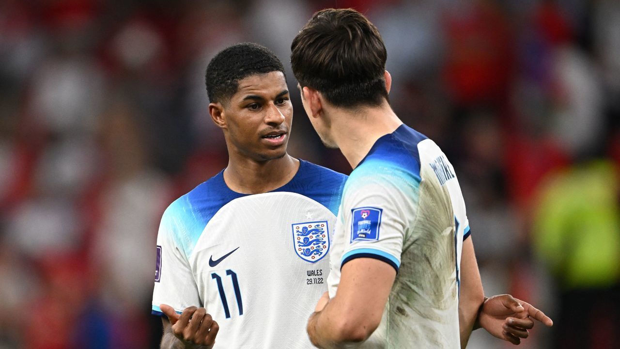England's defender #06 Harry Maguire and England's forward #11 Marcus Rashford greet each other after defeating Wales 3-0 in the Qatar 2022 World Cup Group B football match between Wales and England at the Ahmad Bin Ali Stadium in Al-Rayyan, west of Doha on November 29, 2022.