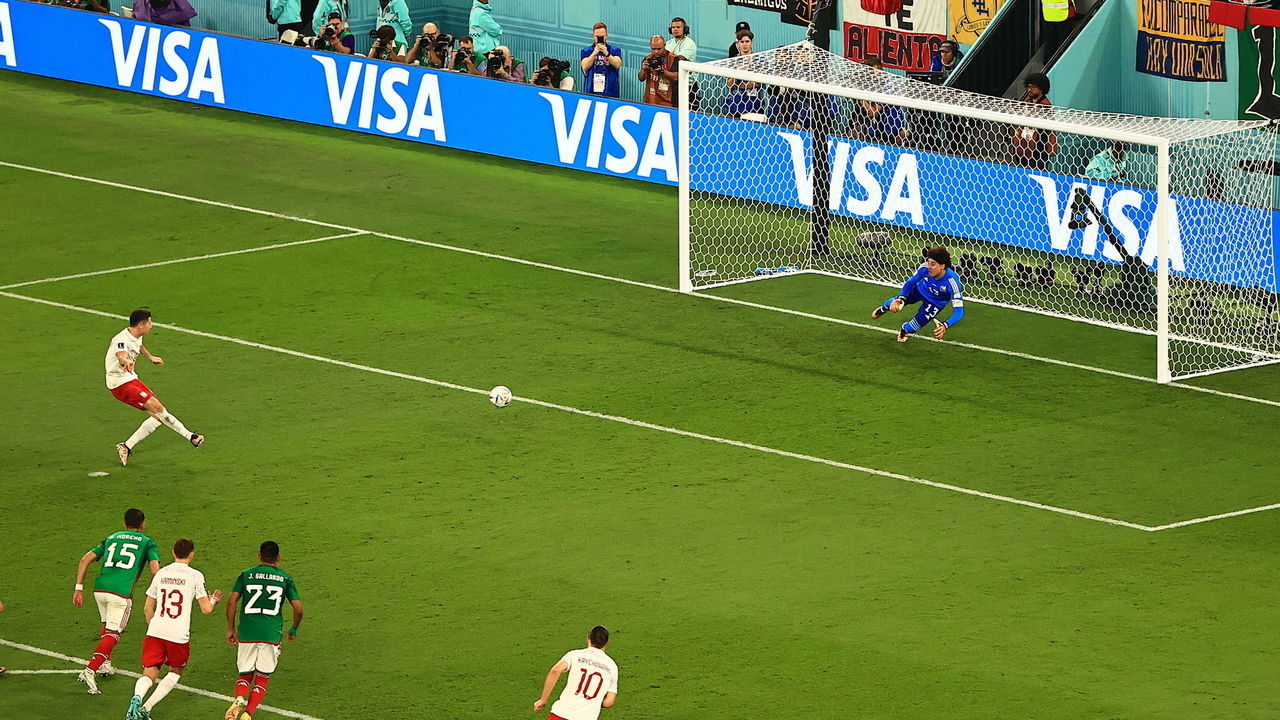 DOHA, QATAR - NOVEMBER 22: Robert Lewandowski (9) of Poland shoots a penalty kick during the FIFA World Cup Qatar 2022 Group C match between Mexico and Poland at Stadium 974 on November 22, 2022 in Doha, Qatar.
