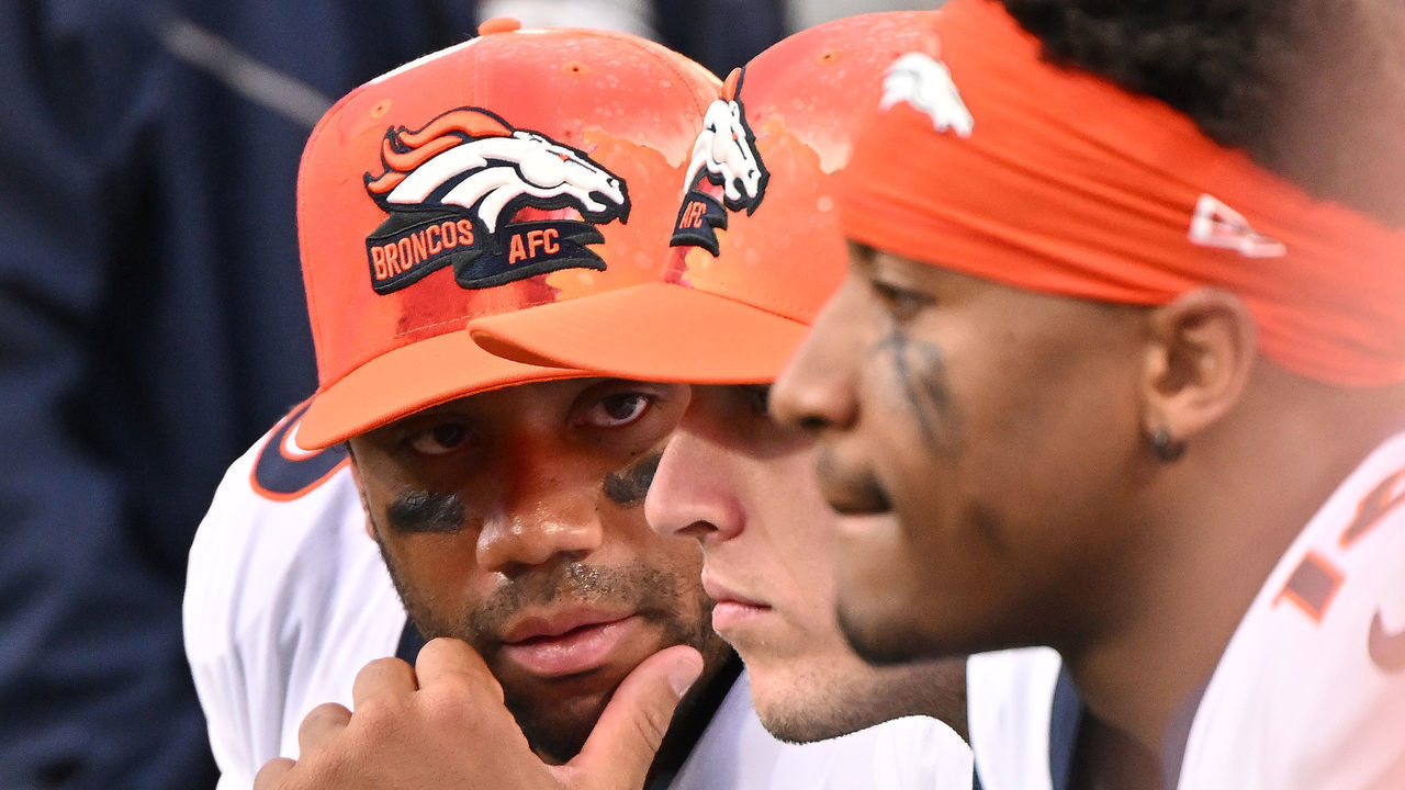 CHARLOTTE, NORTH CAROLINA - NOVEMBER 27: Russell Wilson #3 of the Denver Broncos confers with teammates on the sideline during their game against the Carolina Panthers at Bank of America Stadium on November 27, 2022 in Charlotte, North Carolina.