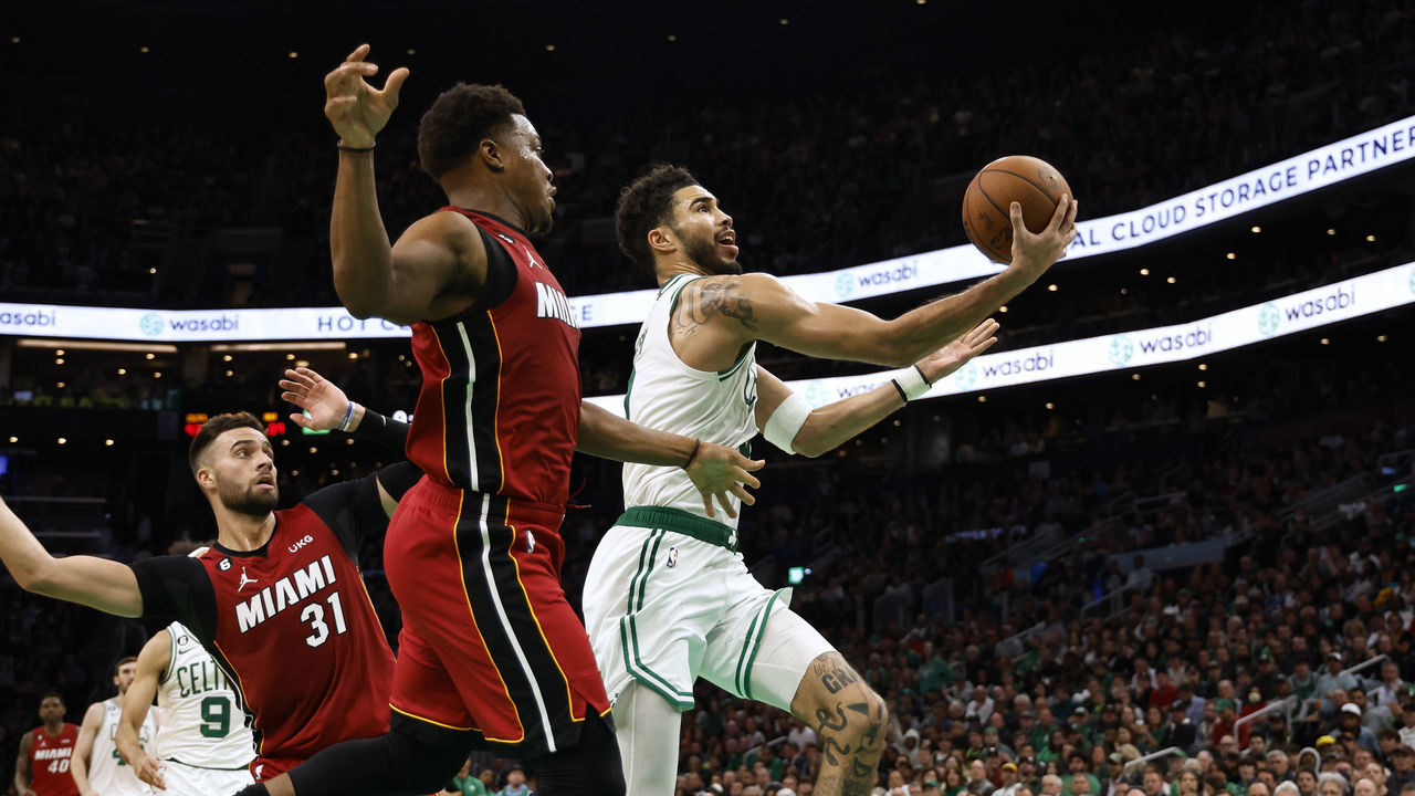 BOSTON, MA - NOVEMBER 30: Jayson Tatum #0 of the Boston Celtics goes to the basket past Max Strus #31 of the Miami Heat and Kyle Lowry during the second half at TD Garden on November 30, 2022 in Boston, Massachusetts. NOTE TO USER: User expressly acknowledges and agrees that, by downloading and/or using this Photograph, user is consenting to the terms and conditions of the Getty Images License Agreement.