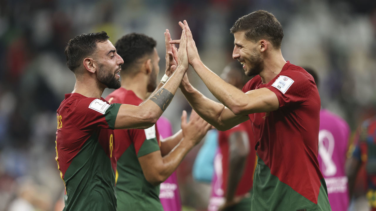 LUSAIL CITY, QATAR - NOVEMBER 28: Bruno Fernandes and Ruben Dias of Portugal celebrate winning the game at full time during the FIFA World Cup Qatar 2022 Group H match between Portugal and Uruguay at Lusail Stadium on November 28, 2022 in Lusail City, Qatar.