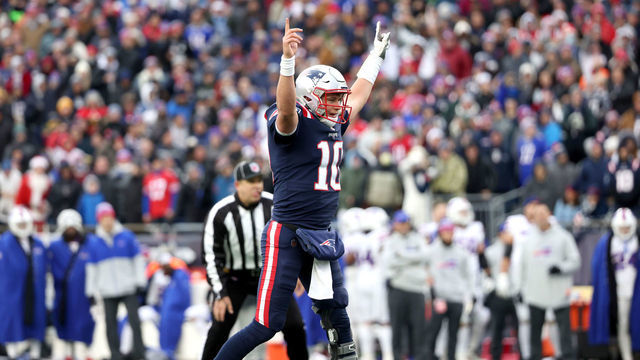 Foxborough, MA - December 26: Quarterback Mac Jones reacted after Damien Harris made a touchdown in the third quarter. The New England Patriots host the Buffalo Bills in an NFL game on Sunday, Dec. 26, 2021 at Gillette Stadium in Foxborough, MA.