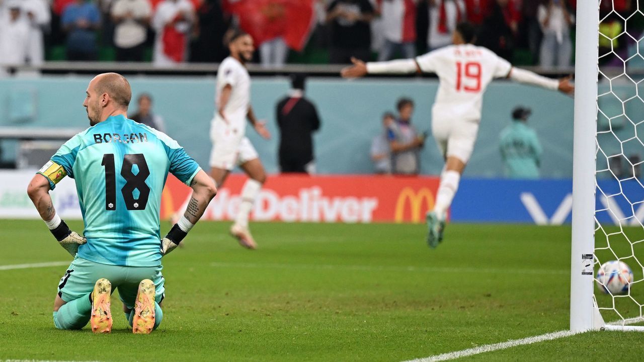 Canada's goalkeeper #18 Milan Borjan (L) looks dejected after Morocco's forward #19 Youssef En-Nesyri (R) scored his team's second goal during the Qatar 2022 World Cup Group F football match between Canada and Morocco at the Al-Thumama Stadium in Doha on December 1, 2022.