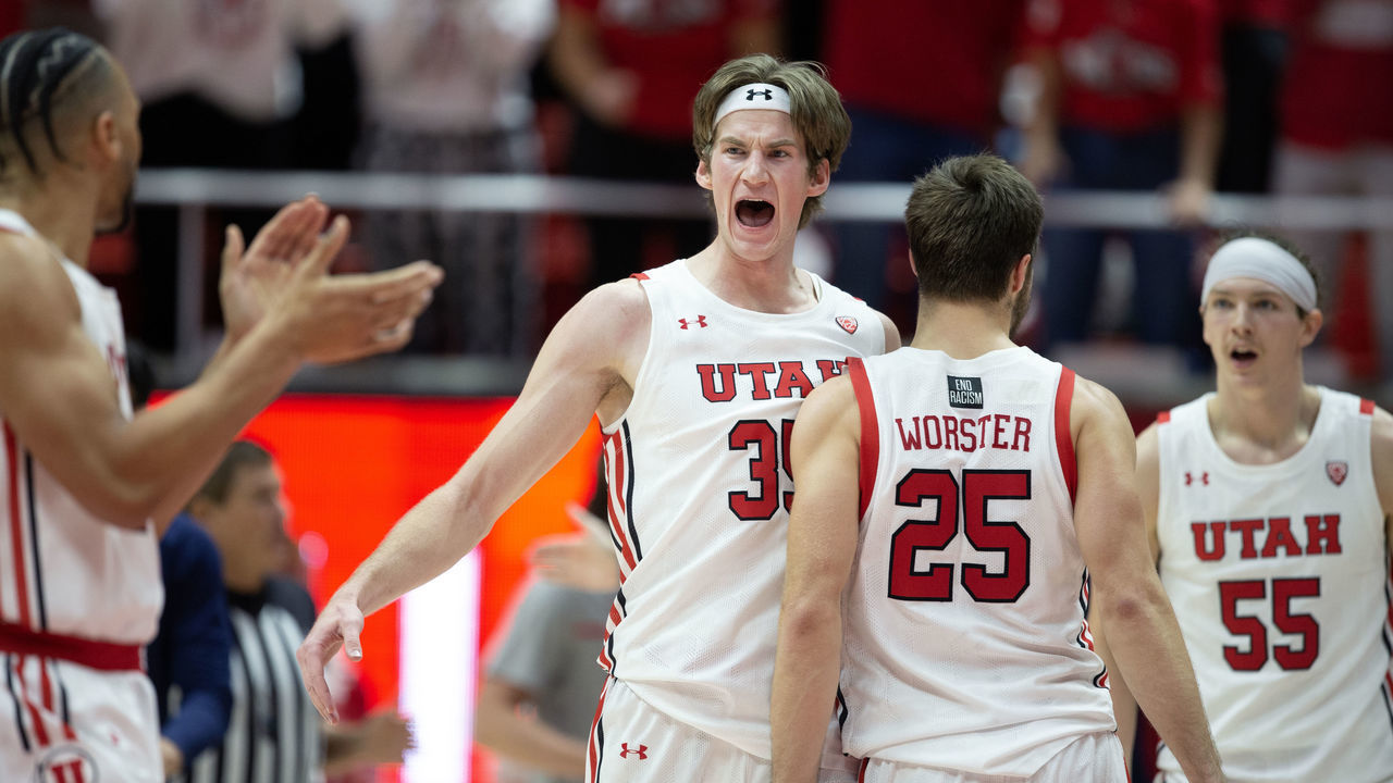 SALT LAKE CITY, UT - DECEMBER 1: Branden Carlson #35 of the Utah Utes reacts as he gathers with teammates Marco Anthony #10, Rollie Worster #25, and Gabe Madsen #55 during the second half of their game against the Arizona Wildcats at the Jon M. Huntsman Center December 1, 2022 in Salt Lake City, Utah.