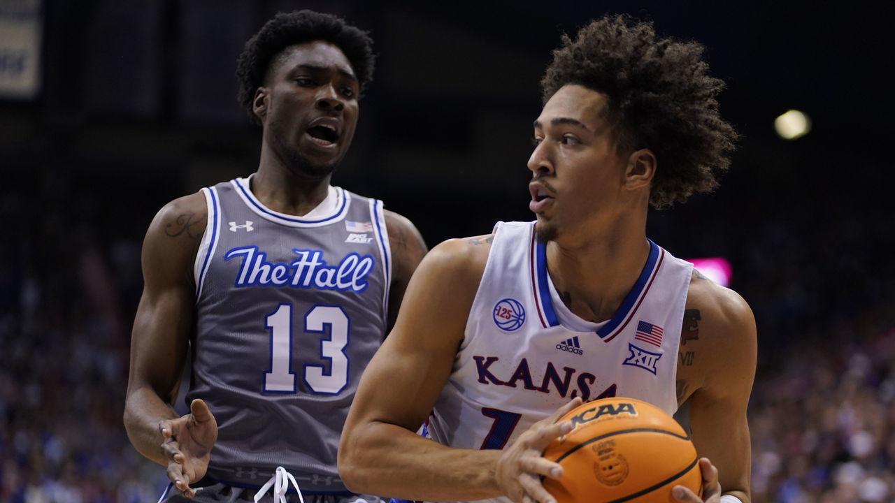 LAWRENCE, KANSAS - DECEMBER 01: Jalen Wilson #10 of the Kansas Jayhawks looks to pass as he is defended by KC Ndefo #13 of the Seton Hall Pirates in the first half at Allen Fieldhouse on December 01, 2022 in Lawrence, Kansas.