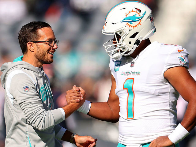 CHICAGO, ILLINOIS - NOVEMBER 06: Head coach Mike McDaniel of the Miami Dolphins speaks with Tua Tagovailoa #1 prior to the game against the Chicago Bears at Soldier Field on November 06, 2022 in Chicago, Illinois.