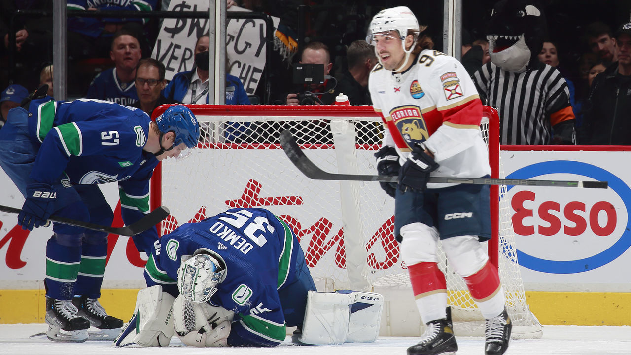 VANCOUVER, CANADA - DECEMBER 1: Ryan Lomberg #94 of the Florida Panthers skates to the bench after scoring as Tyler Myers #57 helps Thatcher Demko #35 of the Vancouver Canucks during the first period of their NHL game against the Florida Panthers at Rogers Arena December 1, 2022 in Vancouver, British Columbia, Canada.