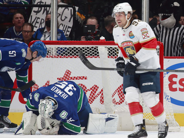 VANCOUVER, CANADA - DECEMBER 1: Ryan Lomberg #94 of the Florida Panthers skates to the bench after scoring as Tyler Myers #57 helps Thatcher Demko #35 of the Vancouver Canucks during the first period of their NHL game against the Florida Panthers at Rogers Arena December 1, 2022 in Vancouver, British Columbia, Canada.