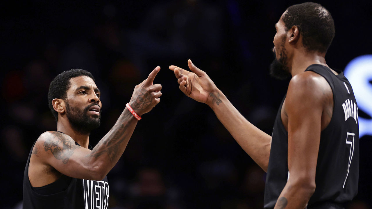 NEW YORK, NEW YORK - DECEMBER 2: Kyrie Irving #11 of the Brooklyn Nets reacts with teammate Kevin Durant #7 against the Toronto Raptors during the second half at Barclays Center on December 2, 2022 in New York City. The Nets won 114-105.