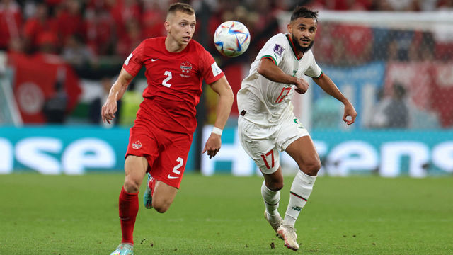 Canada's defender #02 Alistair Johnston fights for the ball with Morocco's midfielder #17 Sofiane Boufal during the Qatar 2022 World Cup Group F football match between Canada and Morocco at the Al-Thumama Stadium in Doha on December 1, 2022.