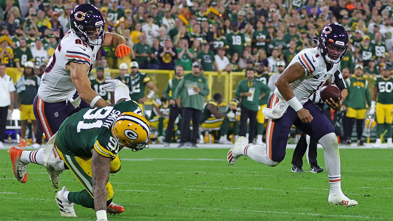 GREEN BAY, WISCONSIN - SEPTEMBER 18: Justin Fields #1 of the Chicago Bears is pursued by Preston Smith #91 of the Green Bay Packers during a game at Lambeau Field on September 18, 2022 in Green Bay, Wisconsin. The Packers defeated the Bears 27-10.