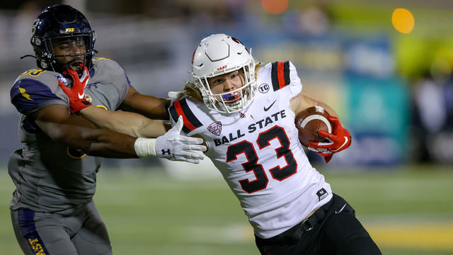 KENT, OH - NOVEMBER 01: Ball State Cardinals running back Carson Steele (33) fights off the tackle attempt of Kent State Golden Flashes linebacker Marvin Pierre (33) as he scores on a 15-yard touchdown run during the second quarter of the college football game between the Ball State Cardinals and Kent State Golden Flashes on November 1, 2022, at Dix Stadium in Kent, OH.