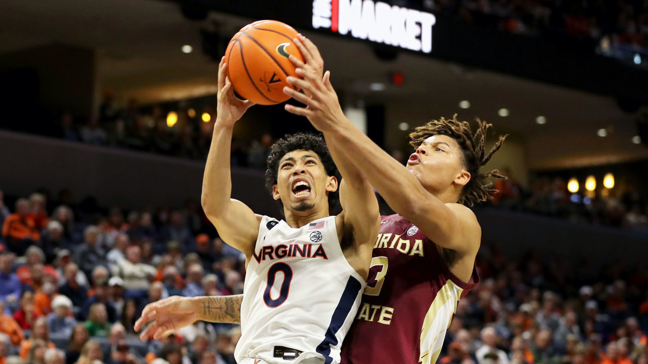 CHARLOTTESVILLE, VA - DECEMBER 03: Kihei Clark #0 of the Virginia Cavaliers shoots past Cameron Corhen #3 of the Florida State Seminoles in the second half during a game at John Paul Jones Arena on December 3, 2022 in Charlottesville, Virginia.