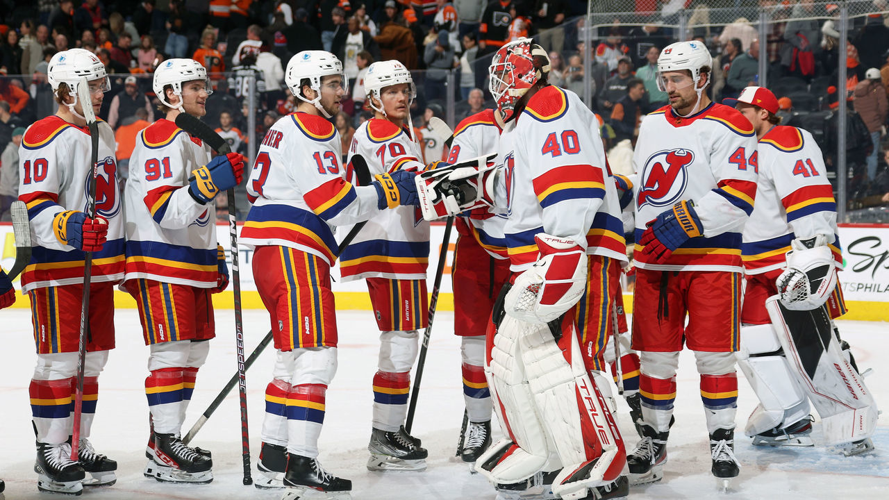 PHILADELPHIA, PENNSYLVANIA - DECEMBER 03: Goaltender Akria Schmid #40 and Nico Hischier #13 of the New Jersey Devils celebrate with teammates after defeating the Philadelphia Flyers 3-2 at the Wells Fargo Center on December 3, 2022 in Philadelphia, Pennsylvania.