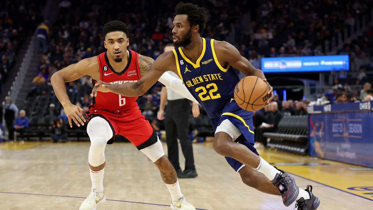 SAN FRANCISCO, CALIFORNIA - DECEMBER 03: Andrew Wiggins #22 of the Golden State Warriors is guarded by Kenyon Martin Jr. #6 of the Houston Rockets at Chase Center on December 03, 2022 in San Francisco, California.