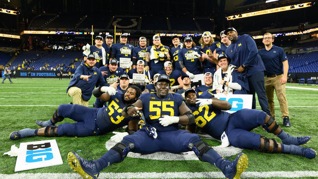 INDIANAPOLIS, IN - DECEMBER 03: Michigan Wolverines offensive lineman Olusegun Oluwatimi (55) celebrates with teammates after the Big 10 Championship game between the Michigan Wolverines and Purdue Boilermakers on December 3, 2022, at Lucas Oil Stadium in Indianapolis, IN.
