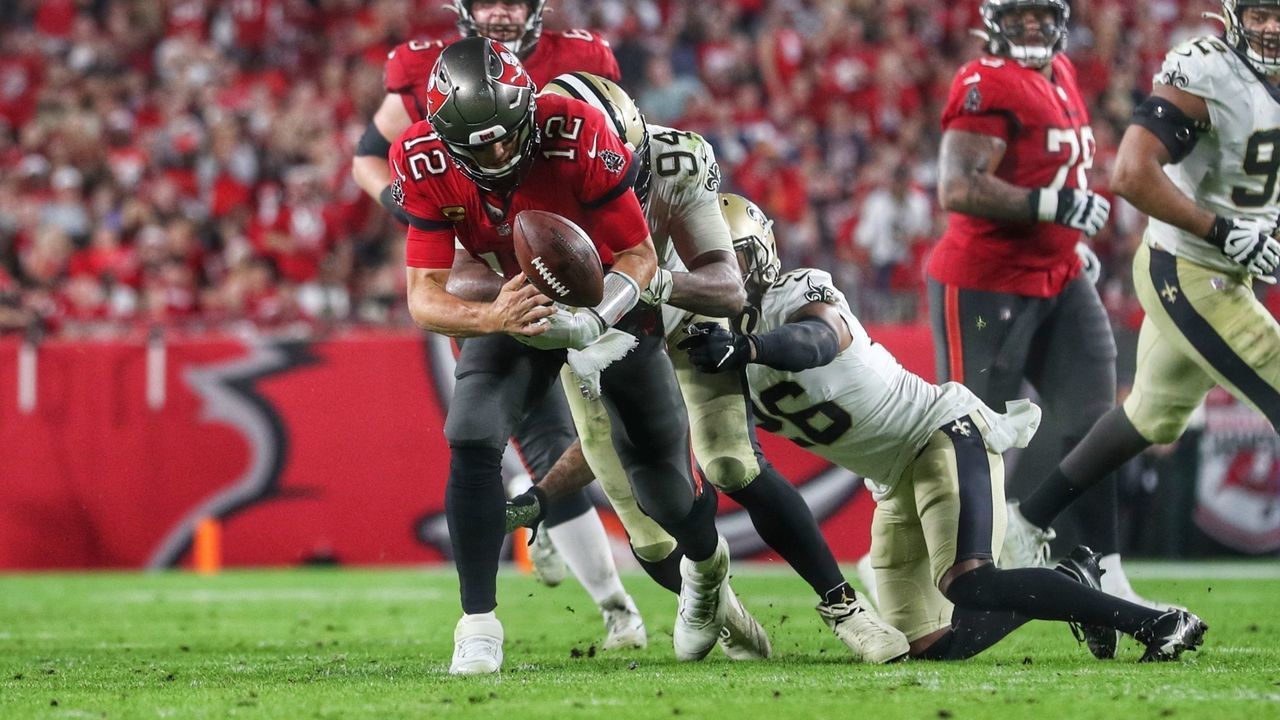 TAMPA, FL - DECEMBER 19: Tampa Bay Buccaneers Quarterback Tom Brady (12) fumbles the ball and the New Orleans Saints recover during the regular season game between the New Orleans Saints and the Tampa Bay Buccaneers on December 19, 2021 at Raymond James Stadium in Tampa, Florida.