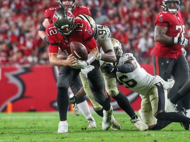 TAMPA, FL - DECEMBER 19: Tampa Bay Buccaneers Quarterback Tom Brady (12) fumbles the ball and the New Orleans Saints recover during the regular season game between the New Orleans Saints and the Tampa Bay Buccaneers on December 19, 2021 at Raymond James Stadium in Tampa, Florida.