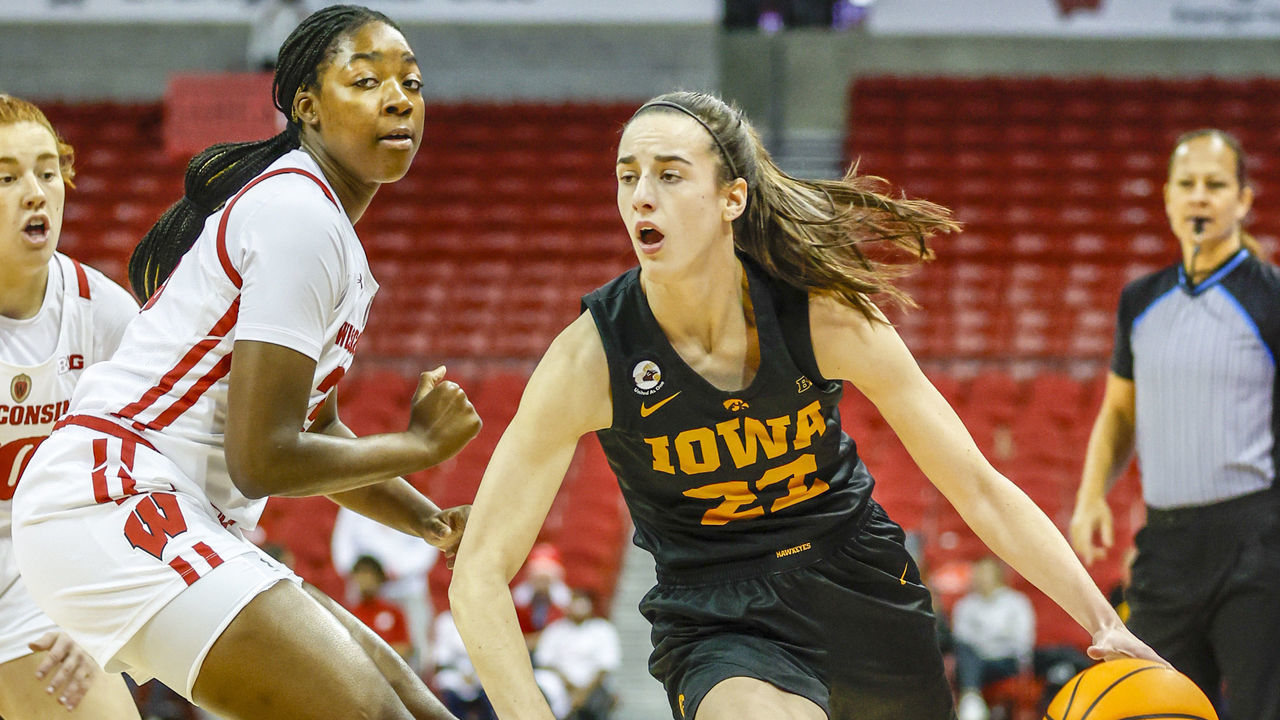 MADISON, WI - DECEMBER 04: Iowa guard Caitlin Clark (22) gets around Wisconsin forward Serah Williams (25) during a college basketball game between the University of Wisconsin Badgers and the University of Iowa Hawkeyes on December 4, 2022 at the Kohl Center in Madison, WI.