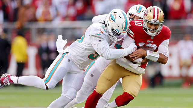 SANTA CLARA, CALIFORNIA - DECEMBER 04: Jaelan Phillips #15 of the Miami Dolphins and Jerome Baker #55 of the Miami Dolphins sack Jimmy Garoppolo #10 of the San Francisco 49ers during the first quarter at Levi's Stadium on December 04, 2022 in Santa Clara, California.