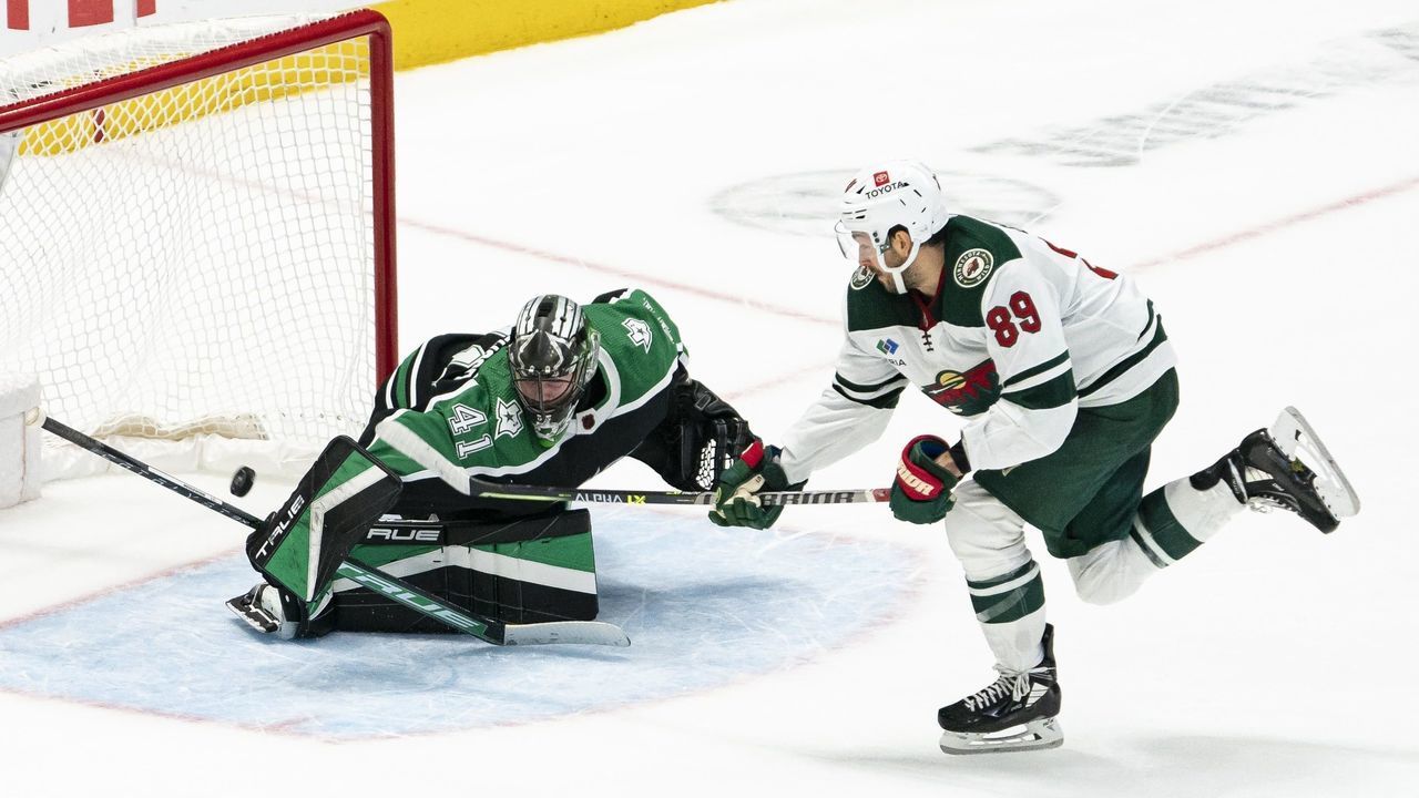 DALLAS, TEXAS - DECEMBER 04: Frederick Gaudreau #89 of the Minnesota Wild makes a shot over Scott Wedgewood #41 of the Dallas Stars during shootouts at American Airlines Center on December 04, 2022 in Dallas, Texas.
