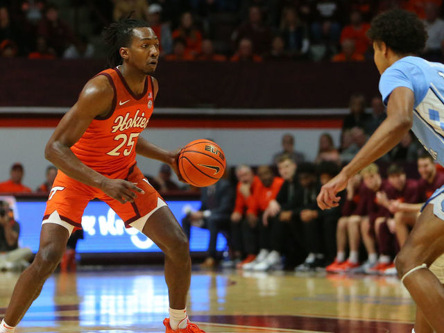 BLACKSBURG, VA - DECEMBER 04: North Carolina Tar Heels guard Puff Johnson (14) attempts to defend Virginia Tech Hokies forward Justyn Mutts (25) during a men's college basketball game between the North Carolina Tar Heels and the Virginia Tech Hokies on December 04, 2022, at Cassell Coliseum in Blacksburg, VA.