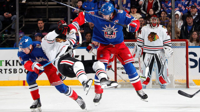 NEW YORK, NEW YORK - DECEMBER 03: Jacob Trouba #8 of the New York Rangers throws a hit against Andreas Athanasiou #89 of the Chicago Blackhawks at Madison Square Garden on December 3, 2022 in New York City.