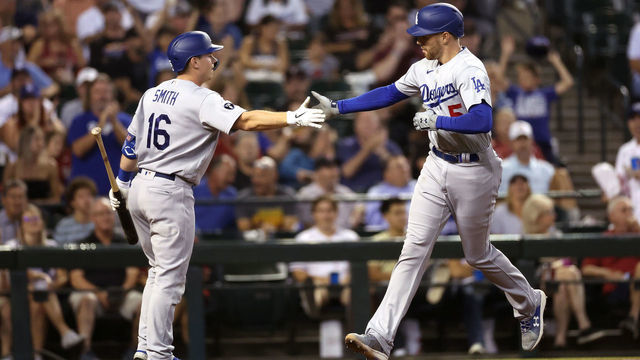 PHOENIX, ARIZONA - SEPTEMBER 13: Freddie Freeman #5 of the Los Angeles Dodgers high fives Will Smith #16 after hitting a solo home run against the Arizona Diamondbacks during the third inning of the MLB game at Chase Field on September 13, 2022 in Phoenix, Arizona.