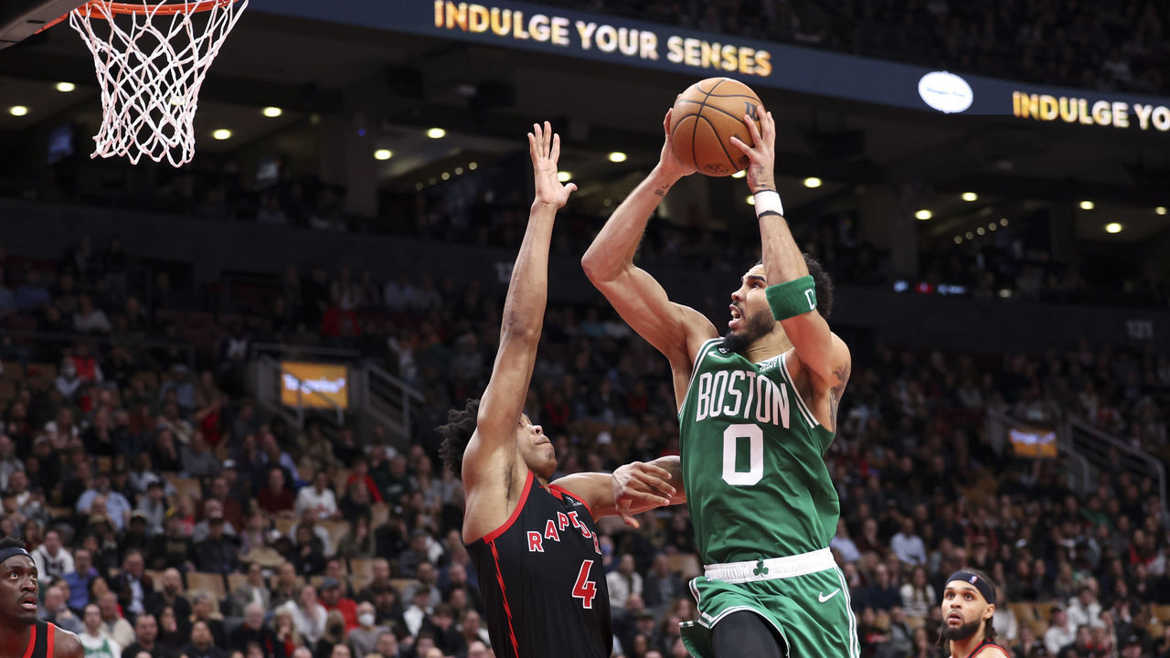 TORONTO, ON - December 5 In second half action, Boston Celtics forward Jayson Tatum (0) goes up for a bucket over Toronto Raptors forward Scottie Barnes (4) The Toronto Raptors lost to the Boston Celtics 116-110 in NBA basketball action at the Scotiabank Arena in Toronto. December 5 2022 (Richard Lautens/Toronto Star via Getty Images)