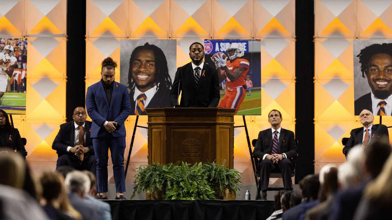 CHARLOTTESVILLE, VIRGINIA - NOVEMBER 19: A football player speaks to a crowd during a memorial service for three slain University of Virginia football players Lavel Davis Jr., D'Sean Perry and Devin Chandler at John Paul Jones Arena at the school on November 19, 2022 in Charlottesville, Virginia. Christopher Darnell Jones Jr. was apprehended in connection with the November 13 shooting in which three university football players were killed and two others wounded.
