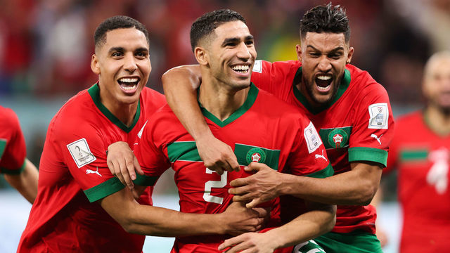 AL RAYYAN, QATAR - DECEMBER 06: Achraf Hakimi of Morocco celebrates with teammates after scoring the winning penalty in the shootout during the FIFA World Cup Qatar 2022 Round of 16 match between Morocco and Spain at Education City Stadium on December 06, 2022 in Al Rayyan, Qatar.
