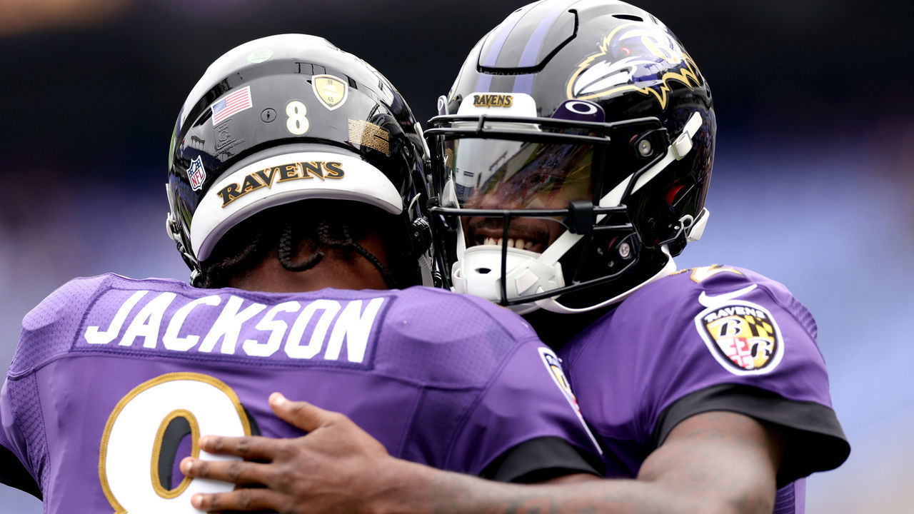 BALTIMORE, MARYLAND - OCTOBER 23: Lamar Jackson #8 of the Baltimore Ravens greets Tyler Huntley #2 during warmups before the game against the Cleveland Browns at M&T Bank Stadium on October 23, 2022 in Baltimore, Maryland.