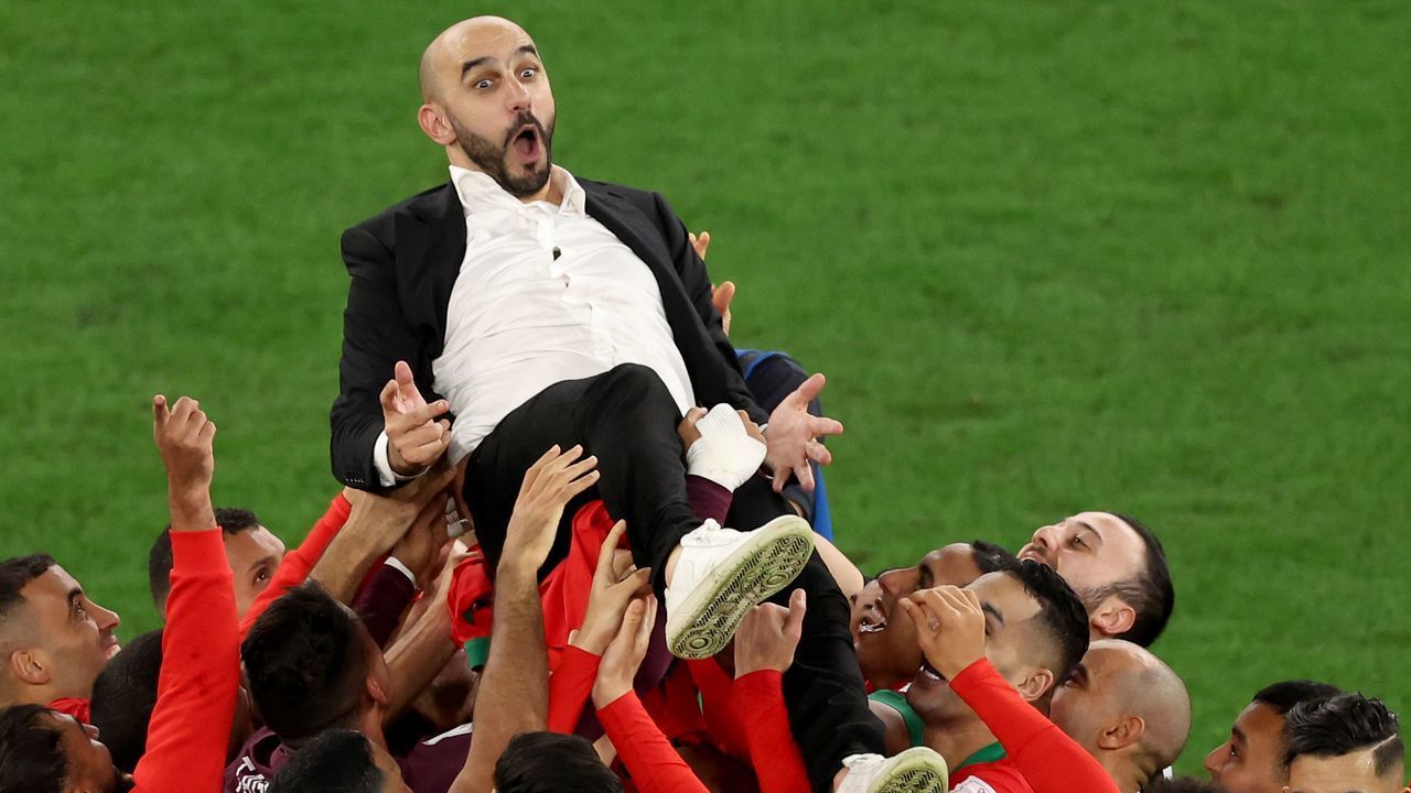 AL RAYYAN, QATAR - DECEMBER 06: Walid Regragui, Head Coach of Morocco, celebrates with players after the team's victory in the penalty shoot out during the FIFA World Cup Qatar 2022 Round of 16 match between Morocco and Spain at Education City Stadium on December 06, 2022 in Al Rayyan, Qatar.