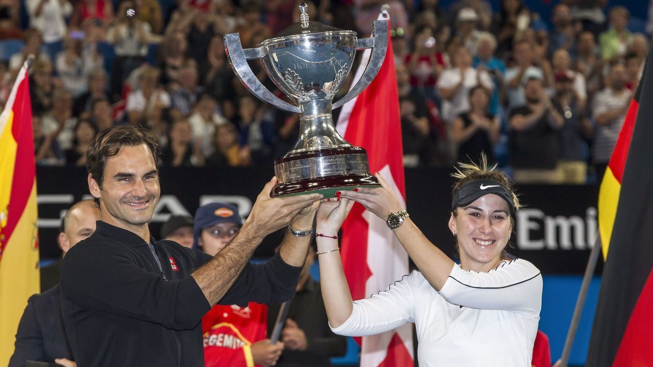 Roger Federer and his mixed doubles partner Belinda Bencic of Switzerland with the Hopman Cup after defeating runners-up Alexander Zverev and Angelique Kerber of Germany in the final on day eight of the Hopman Cup tennis tournament in Perth on January 5, 2019.