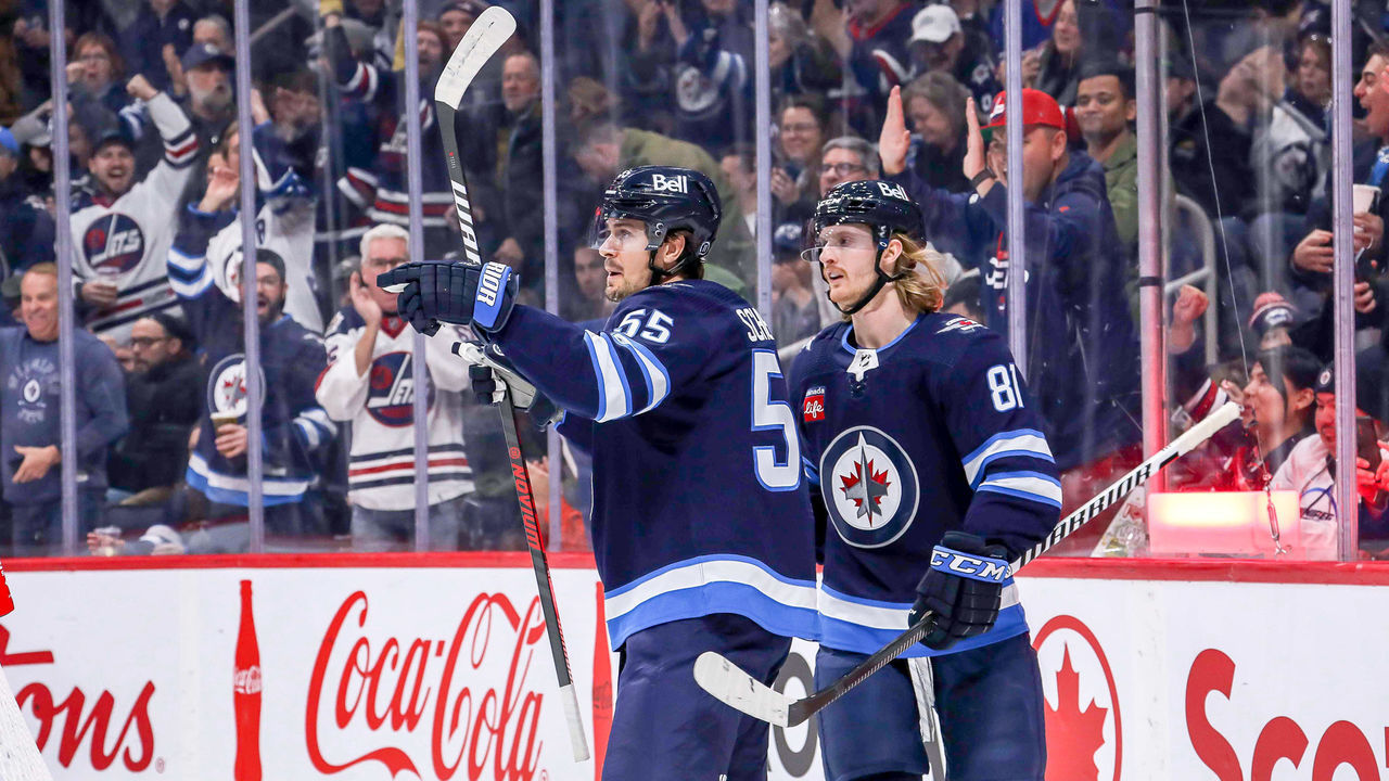 WINNIPEG, CANADA - DECEMBER 6: Mark Scheifele #55 an Kyle Connor #81 of the Winnipeg Jets celebrate a first period goal against the Florida Panthers at the Canada Life Centre on December 6, 2022 in Winnipeg, Manitoba, Canada.