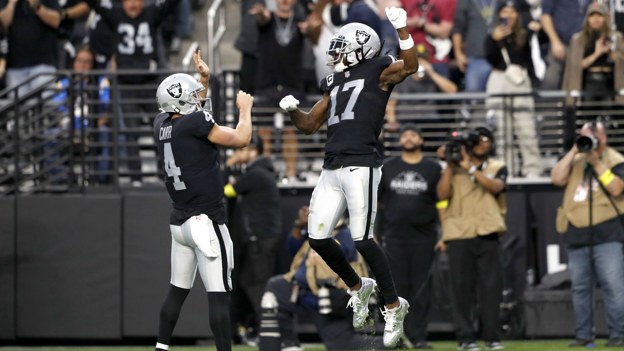 LAS VEGAS, NEVADA - DECEMBER 04: Wide receiver Davante Adams #17 of the Las Vegas Raiders celebrates with quarterback Derek Carr #4 after scoring a touchdown in the third quarter against the Los Angeles Chargers at Allegiant Stadium on December 04, 2022 in Las Vegas, Nevada.
