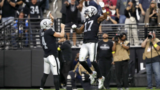 LAS VEGAS, NEVADA - DECEMBER 04: Wide receiver Davante Adams #17 of the Las Vegas Raiders celebrates with quarterback Derek Carr #4 after scoring a touchdown in the third quarter against the Los Angeles Chargers at Allegiant Stadium on December 04, 2022 in Las Vegas, Nevada.