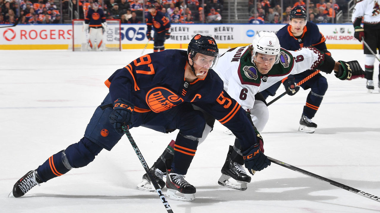 EDMONTON, CANADA - DECEMBER 7: Connor McDavid #97 of the Edmonton Oilers skates against Jakob Chychrun #6 of the Arizona Coyotes during the game on December 7, 2022 at Rogers Place in Edmonton, Alberta, Canada.