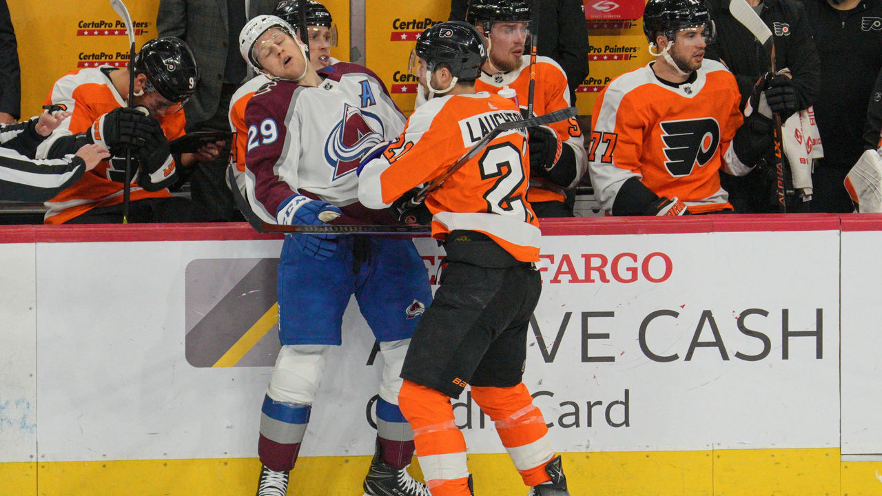 PHILADELPHIA, PA - DECEMBER 05: Colorado Avalanche center Nathan MacKinnon (29) is body checked by Philadelphia Flyers center Scott Laughton (21) during the game between the Colorado Avalanche and the Philadelphia Flyers on December 5, 2022 at the Wells Fargo Center in Philadelphia, PA
