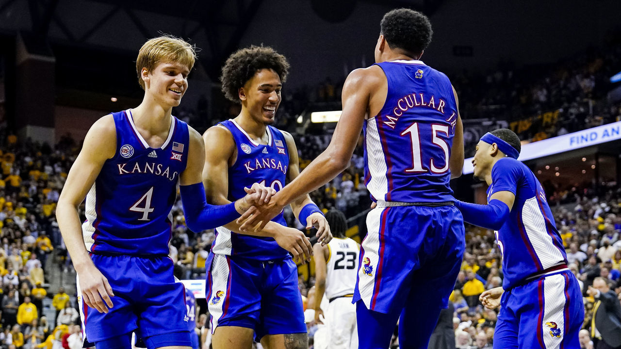 COLUMBIA, MO - DECEMBER 10: Kevin McCullar Jr. #15 of the Kansas Jayhawks is helped to his feet by Gradey Dick #4 and Jalen Wilson #10 and Dajuan Harris Jr. #3 during the second half against the Missouri Tigers at Mizzou Arena on December 10, 2022 in Columbia, Missouri.