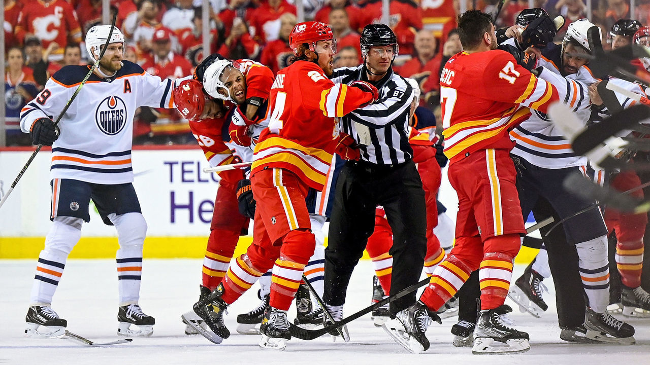 CALGARY, AB - MAY 18: Edmonton Oilers Left Wing Evander Kane (91), Calgary Flames Left Wing Milan Lucic (17), Edmonton Oilers Center Connor McDavid (97), Calgary Flames Defenceman Michael Stone (26) and teammates get physical after a whistle during the first period of game 1 of the second round of the NHL Stanley Cup Playoffs between the Calgary Flames and the Edmonton Oilers on May 18, 2022, at the Scotiabank Saddledome in Calgary, AB.
