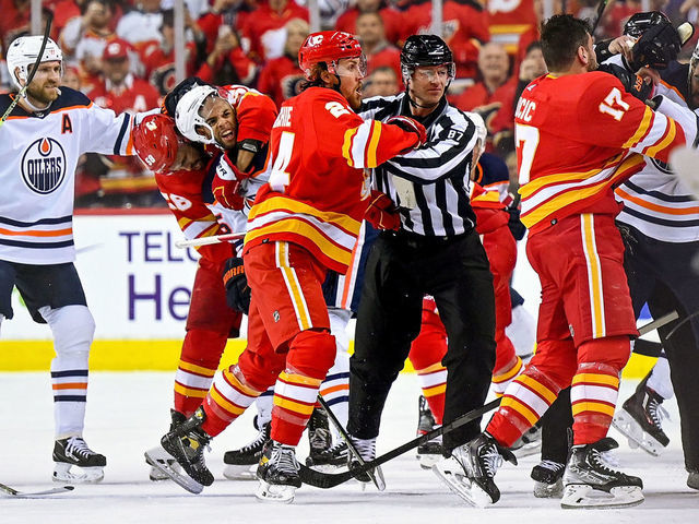 CALGARY, AB - MAY 18: Edmonton Oilers Left Wing Evander Kane (91), Calgary Flames Left Wing Milan Lucic (17), Edmonton Oilers Center Connor McDavid (97), Calgary Flames Defenceman Michael Stone (26) and teammates get physical after a whistle during the first period of game 1 of the second round of the NHL Stanley Cup Playoffs between the Calgary Flames and the Edmonton Oilers on May 18, 2022, at the Scotiabank Saddledome in Calgary, AB.