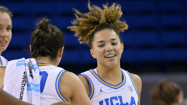 LOS ANGELES, CA - DECEMBER 10: Kiki Rice #1 of the UCLA Bruins smiles as she heads back to the bench for a time out in the first half against the CSU Fullerton Titans at UCLA Pauley Pavilion on December 10, 2022 in Los Angeles, California.