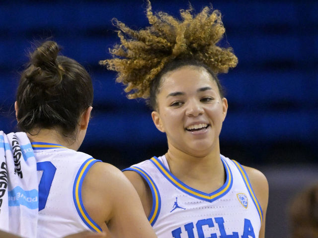 LOS ANGELES, CA - DECEMBER 10: Kiki Rice #1 of the UCLA Bruins smiles as she heads back to the bench for a time out in the first half against the CSU Fullerton Titans at UCLA Pauley Pavilion on December 10, 2022 in Los Angeles, California.