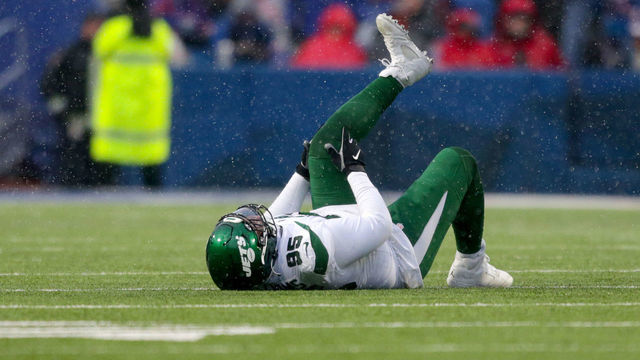 ORCHARD PARK, NEW YORK - DECEMBER 11: Quinnen Williams #95 of the New York Jets lies on the field in the second quarter of a game against the Buffalo Bills at Highmark Stadium on December 11, 2022 in Orchard Park, New York.