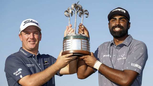 NAPLES, FLORIDA - DECEMBER 11: Tom Hoge and Sahith Theegala of the United States pose with the trophy on the eighteenth green after winning the QBE Shootout at Tiburon Golf Club on December 11, 2022 in Naples, Florida.