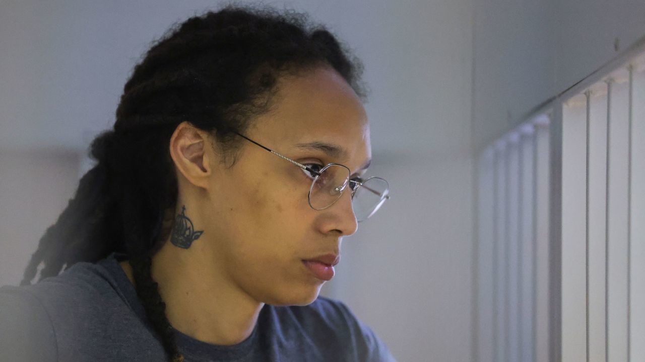 US' Women's National Basketball Association (WNBA) basketball player Brittney Griner, who was detained at Moscow's Sheremetyevo airport and later charged with illegal possession of cannabis, waits for the verdict inside a defendants' cage during a hearing in Khimki outside Moscow, on August 4, 2022. - A Russian court found Griner guilty of smuggling and storing narcotics after prosecutors requested a sentence of nine and a half years in jail for the athlete.