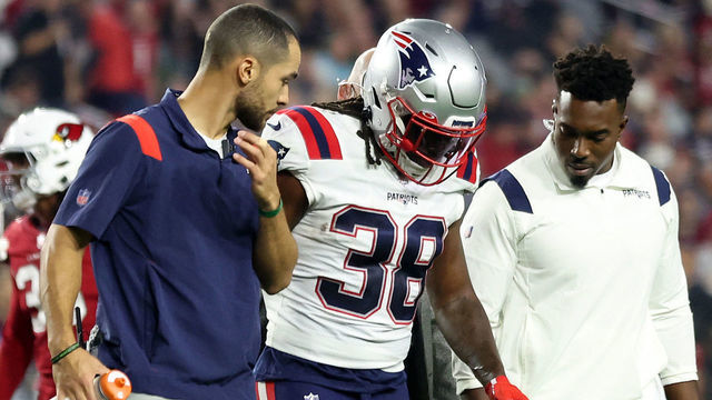 GLENDALE, ARIZONA - DECEMBER 12: Rhamondre Stevenson #38 of the New England Patriots is assisted off the field after a play against the Arizona Cardinals during the first quarter of the game at State Farm Stadium on December 12, 2022 in Glendale, Arizona.