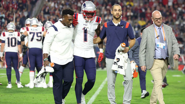 GLENDALE, ARIZONA - DECEMBER 12: DeVante Parker #1 of the New England Patriots is assisted off the field after a play against the Arizona Cardinals during the first quarter of the game at State Farm Stadium on December 12, 2022 in Glendale, Arizona.