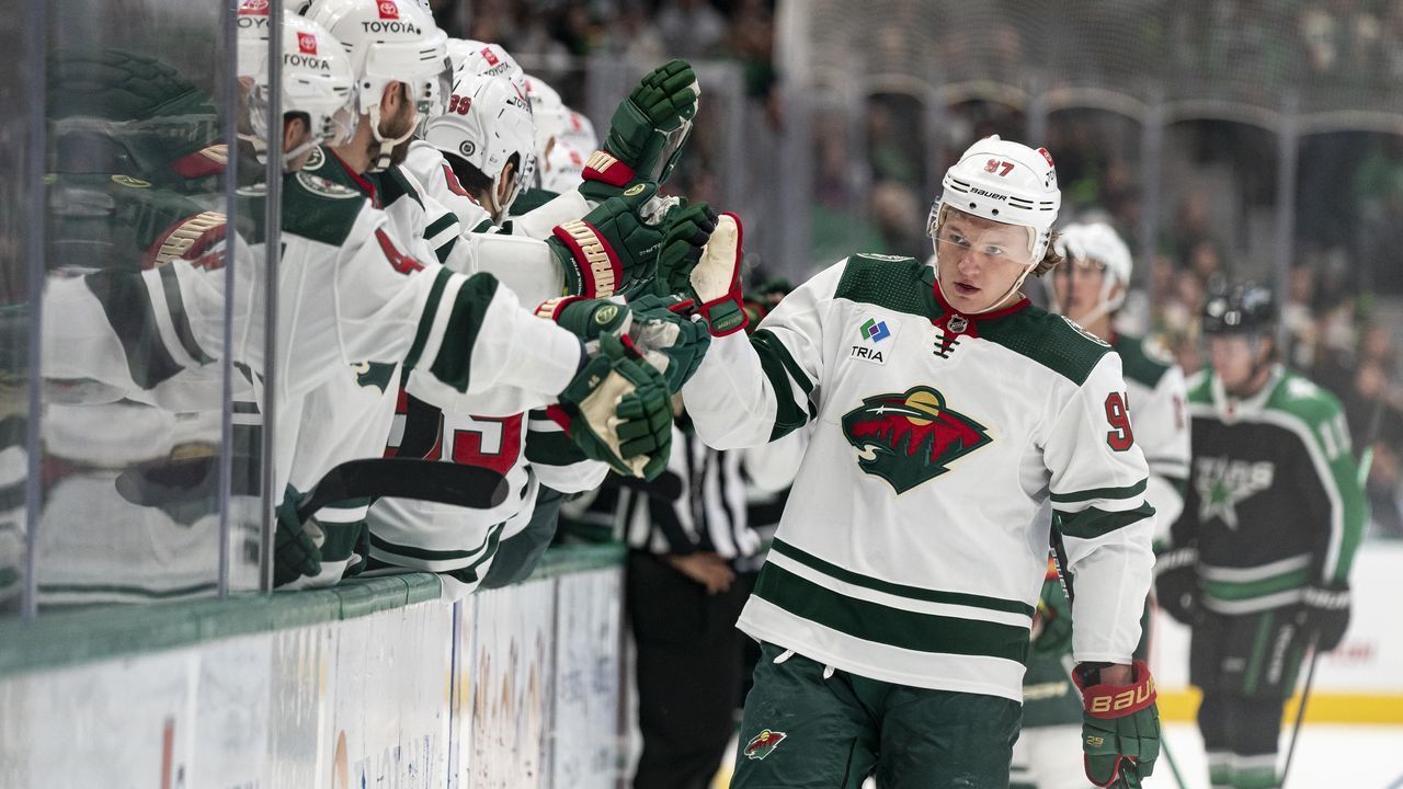 DALLAS, TEXAS - DECEMBER 04: Kirill Kaprizov #97 of the Minnesota Wild is congratulated by teammates after scoring a goal during the first period against the Dallas Stars at American Airlines Center on December 04, 2022 in Dallas, Texas.